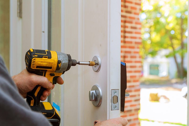 Handyman working on a home's smart lock